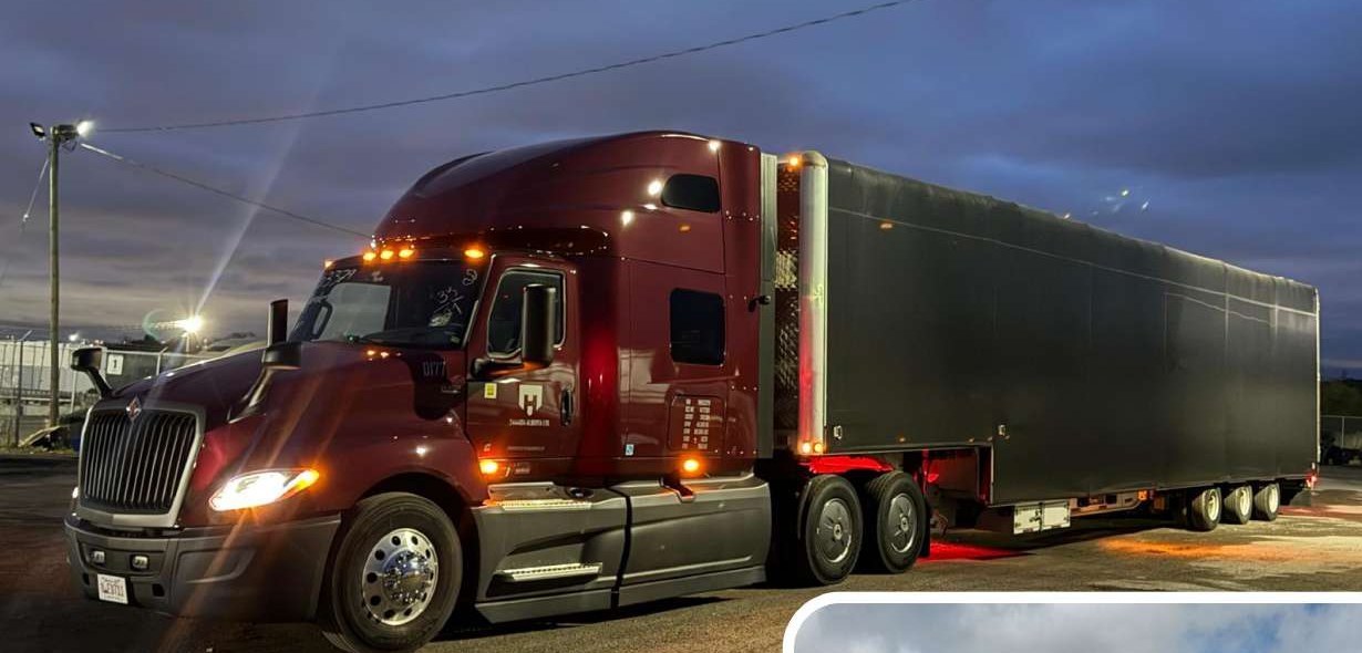 Maroon RG Roadways International semi truck at night